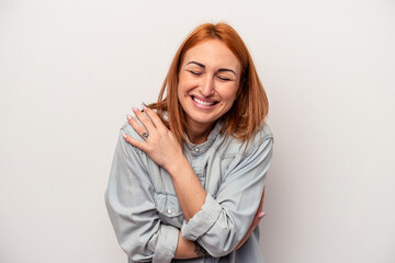Fototapeta premium Young caucasian woman isolated on white background laughing and having fun.