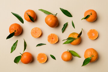 Many fresh ripe mandarin as colored background, top view. Elegant background of clementines and mandarin slices Top view flat lay