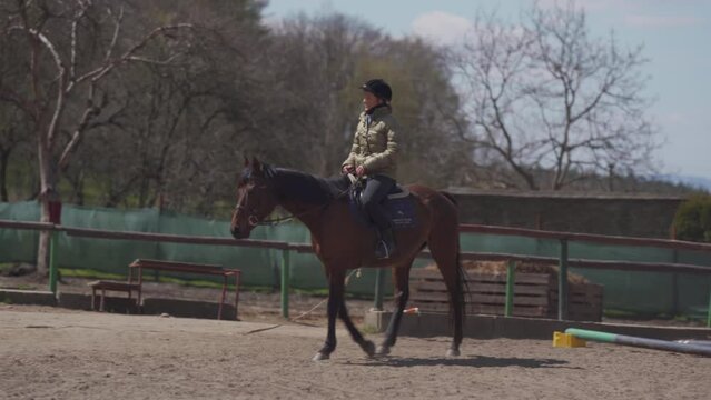 horseback riding in the paddock at the farmyard