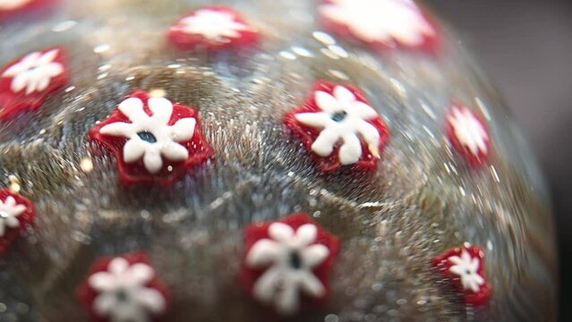 hand blown glass paperweight with beautiful small flower design.  Macro close-up