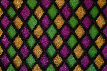 Shiny green, purple and golden glittering paillettes diamonds fabric. Mardi Gras holiday background. © vetre
