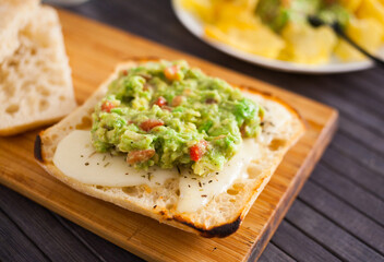 morning toast with melted cheese and guacamol