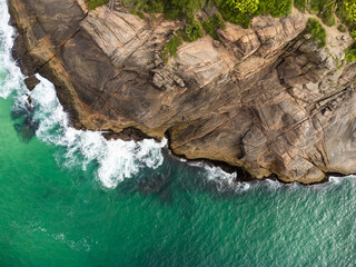 Aerial view of Praia da Joatinga, a paradise in Rio de Janeiro, Brazil. Sunny day with some clouds in the morning. Sea with good waves for surfers. Drone photo