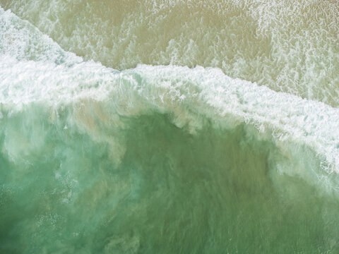 Aerial view of Praia da Joatinga, a paradise in Rio de Janeiro, Brazil. Sunny day with some clouds in the morning. Sea with good waves for surfers. Drone photo