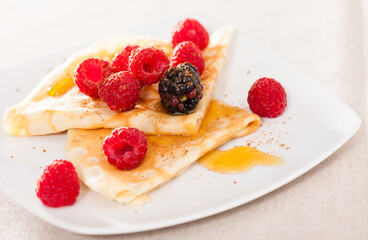 pancakes with raspberries, blackberries and honey