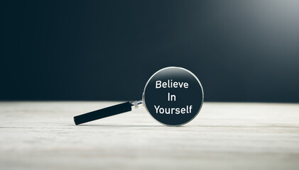 Magnifying glass with text Believe in yourself - obrazy, fototapety, plakaty