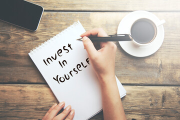 hand with invest in yourself text