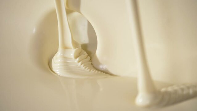 Close-up macro shot melted liquid white chocolate sauce .
