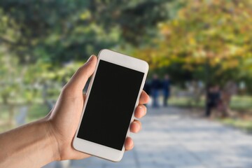 Business and financial concept. Hand with smartphone with a blank screen