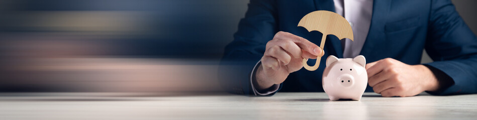 holding  umbrella with piggy bank © ARAMYAN