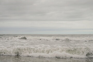 Horizontal Ocaen Waves with Blue Sky in mostly Gray Tones
