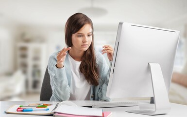 Happy smiling girl student watching learning online video class on a laptop