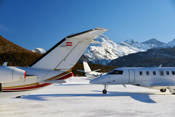 Fototapeta na wymiar Private jets and aircrafts in the airport of Engadine St Moritz in winter time
