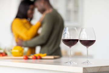 Selective Focus On Two Wine Glasses With Romantic Black Couple On Background