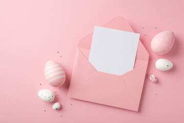 Top view photo of easter decorations open pink envelope with paper sheet confetti pink and white easter eggs on isolated pastel pink background with blank space