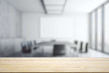 Empty office wooden table with empty space on modern conference room with large window background, closeup, mockup