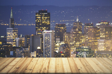 Wooden tabletop with beautiful San Francisco skyscrapers at evening on background, mock up