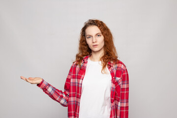 a young girl in a plaid shirt on a light background