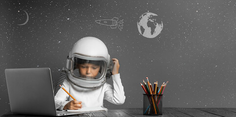 the child studies remotely at school, wearing an astronaut's helmet. back to school