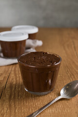 Brazillian chocolate sweet called Brigadeiro in pot on wooden desk background. Vegan version