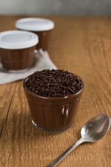 Brazillian chocolate sweet called Brigadeiro in pot on wooden desk background. Vegan version