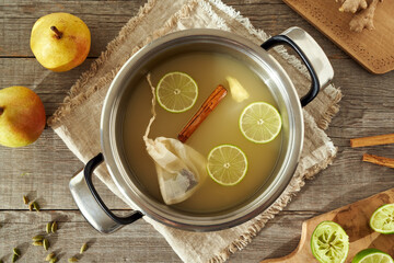 Pear juice with spices in a pot - preparation of a hot pear beverage