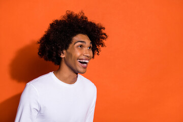 Profile side photo of young guy laughing humorous look empty space isolated over orange color background