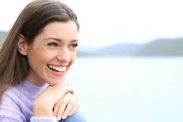Happy woman smiling with white teeth in nature