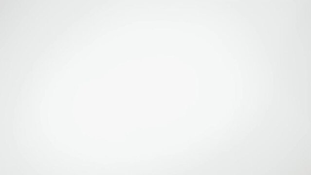 The coffee beans spin rotate quickly fast fly, dispart, splash to the sides with centrifugal coriolis force. The video is in reverse. Coffee beans twist, create pattern, make design figure picture.