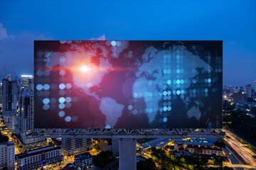 Hologram of Earth planet map on billboard over night panoramic cityscape of Kuala Lumpur, Malaysia, Asia. The concept of international companies in KL. Globe