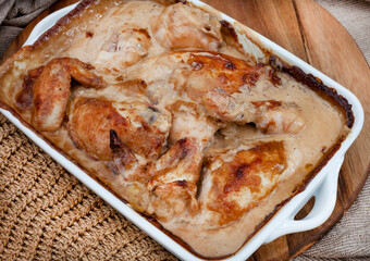 Traditional sweet and tangy South African chicken dish made with Chutney and Mayonnaise sauce. fresh out of the oven on wood and natural woven fabric