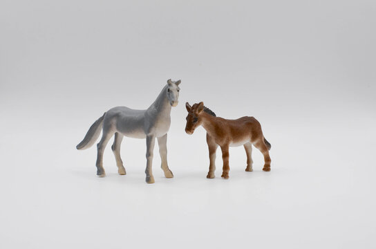 recommend clip art: horse and foal.plastic toy on a white background.