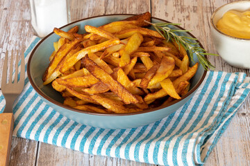 dish of fries on a wooden table