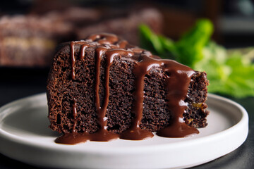 Slice of chocolate cake with glaze on a plate - 487136319
