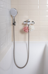 Interior of a modern shower head in a bathroom at home. Modern bathroom design. White bath, shower...