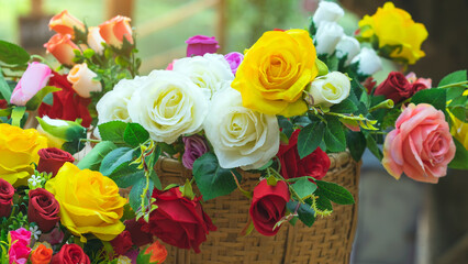 Beautiful bouquet roses flower artificial in vintage wicker basket. Artificial multicolor flowers made from cloth or fabric look like real flower. Retro style.Valentines Day concept. Selective focus.