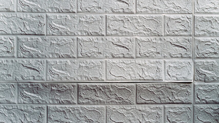 The wallpaper begins to peel off. Old white bricks wallpaper peeled off from the wall inside the room due to moisture or poor quality gluing. Repair and construction services concept. Selective Focus.