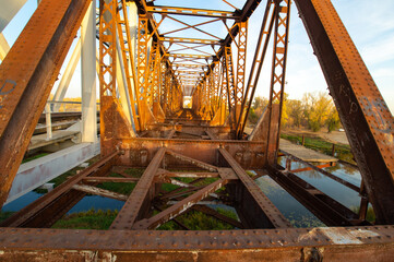 Old metal railway bridge across the river