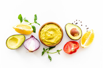 Homemade guacamole avocado dip with tomatoes and lime