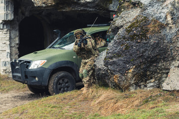 Vigilant soldiers entering cave territory of rebels . High quality photo