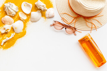 Summertime concept with straw hat and bottles od sunscreen