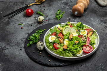Fresh salad with mussels, quail, egg, conjugate, lime, spinach, lettuce, cherry tomatoes and microgreen. Dietary salad. banner, menu, recipe place for text, top view
