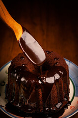 melted chocolate poudered over a chocolate pudding