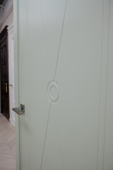 Fototapeta na wymiar Modern wooden white door with metal door handle