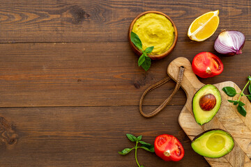 Spicy guacamole avocado dip with herbs and tomatoes