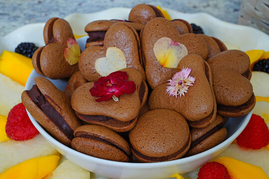 Heart Shaped Chocolate Macaron Cookies With Pressed Edible Flowers For Valentines Day