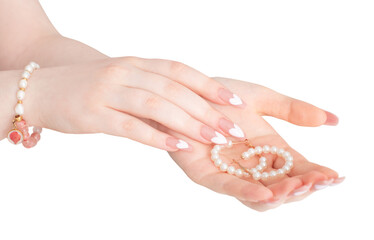 female hands with beautiful long nails with  manicure  and pearl jewelry isolated  on white background