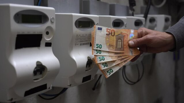 increase in the cost of raw materials due war conflict Ukraine Russia, energy and gas and in household bills - money euro cash banknotes and electrical power plug