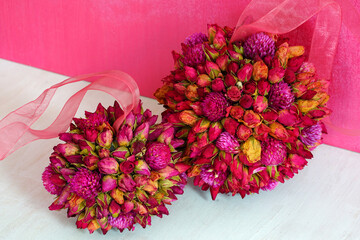 Kissing ball pomander ornament with pink dried roses and gomphrena flowers