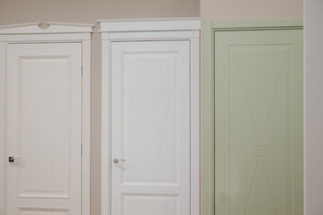 Obraz premium Modern wooden white door with metal door handle